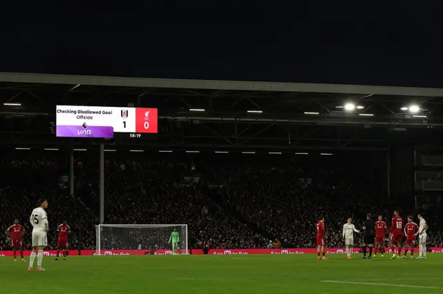 The players wait for VAR to check an offside decision