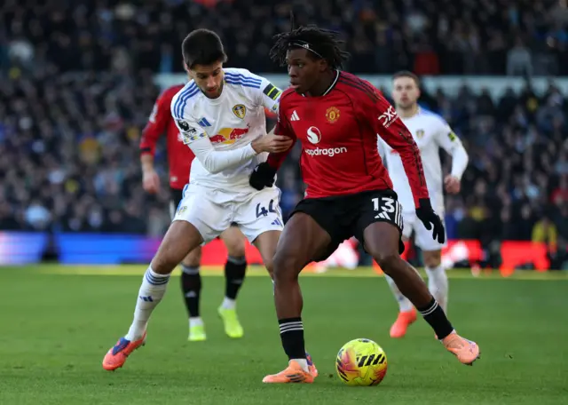 Manchester United's Patrick Dorgu in action with Leeds United's Ilia Gruev