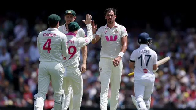 S England's Ben Duckett (R) walks off the ground after being dismissed by Australia's Mitchell Starc (C