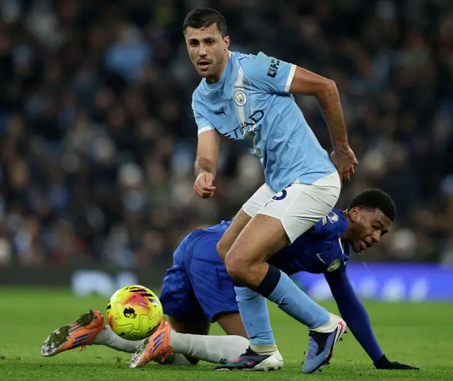Rodri shakes off a challenge in midfield