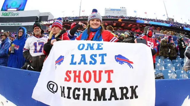 A Buffalo Bills fan holding a sign during the team's final game at Highmark Stadium