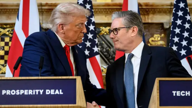 Donald Trump and Keir Starmer shaking hands while stood at two lecterns - there are British and American flags behind them