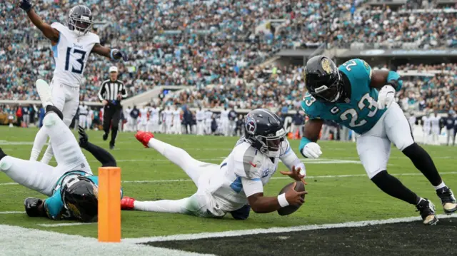 Tennessee Titans quarterback Cam Ward runs for a seven-yard touchdown against the Jacksonville Jaguars