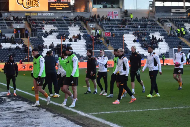 Hull and Watford players walk off after the warm-up was stopped due to the game being postponed
