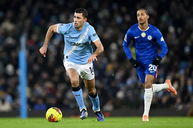 Rodri of Manchester City runs with the ball