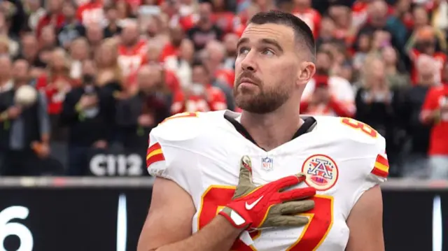Travis Kelce looks on during the national anthem before the Kansas City Chiefs' game at the Las Vegas Raiders in January 2026