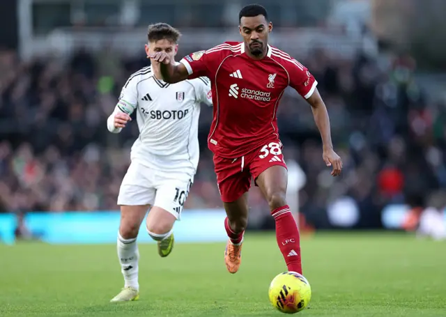 Ryan Gravenberch of Liverpool is challenged by Tom Cairney