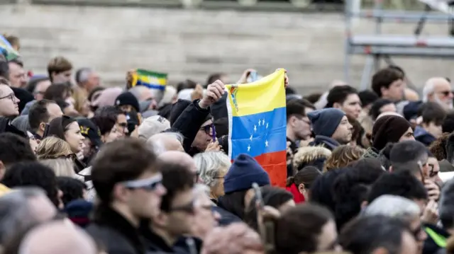 Among the crows in Vatican City, one person waves a Venezuelan flag during Pope Leo's Angelus prayer