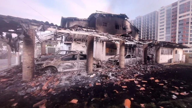 Burned vehicles and damaged structures following US airstrikes at Fuerte Tiuna