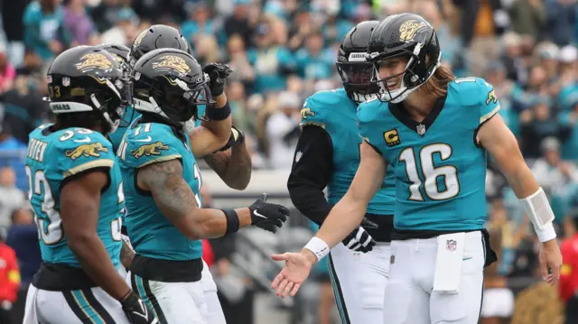 Jacksonville Jaguars wide receiver Parker Washington celebrates with quarterback Trevor Lawrence after scoring a touchdown against the Tennessee Titans