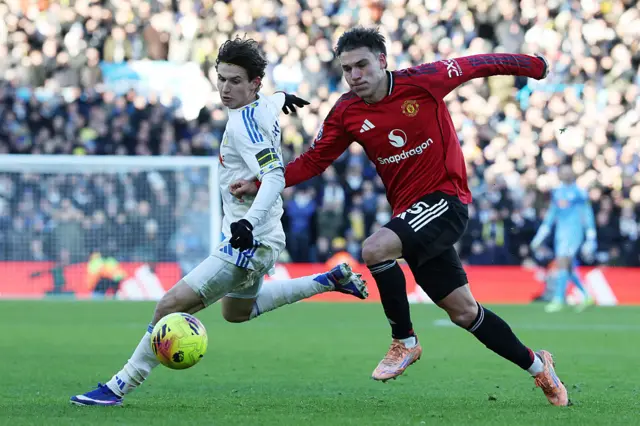 Leeds United's US midfielder #11 Brenden Aaronson (L) tries to beat Manchester United's Uruguayan midfielder #25 Manuel Ugarte