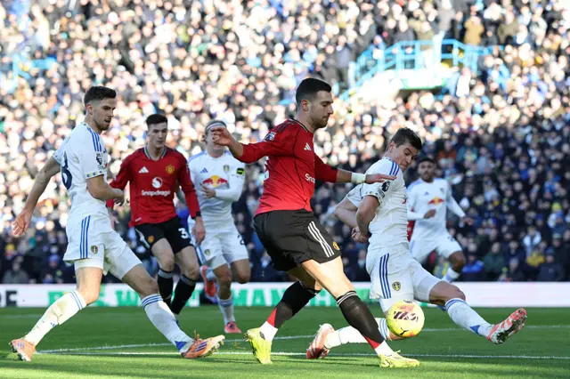 Leeds United's Slovenian defender #15 Jaka Bijol (R) tries to block Manchester United's Portuguese defender #02 Diogo Dalot