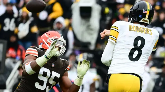 Pittsburgh Steelers quarterback Aaron Rodgers throws over Cleveland Browns defensive end Myles Garrett