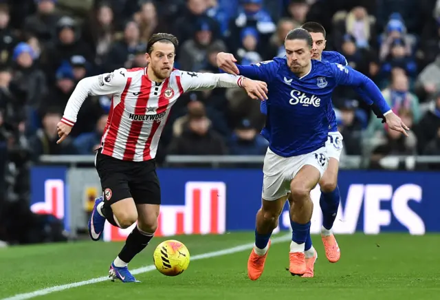 Brentford's Mathias Jensen in action with Everton's Jack Grealish