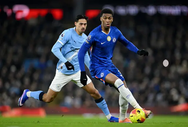 Josh Acheampong of Chelsea runs with the ball