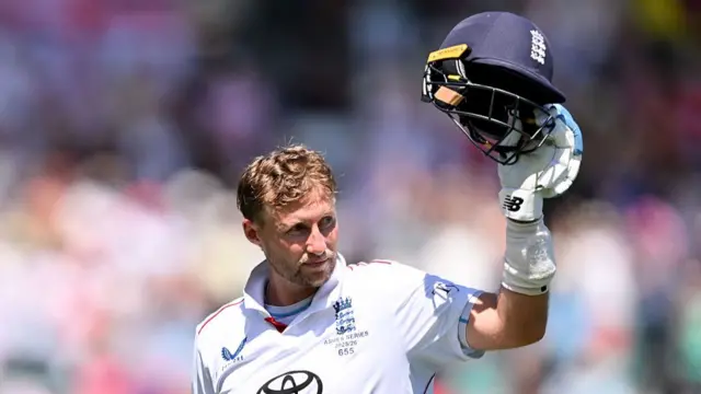 Joe Root raising his helmet in his left hand