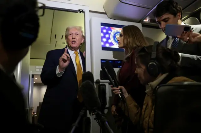 Donald Trump speaks with journalists on Air Force One