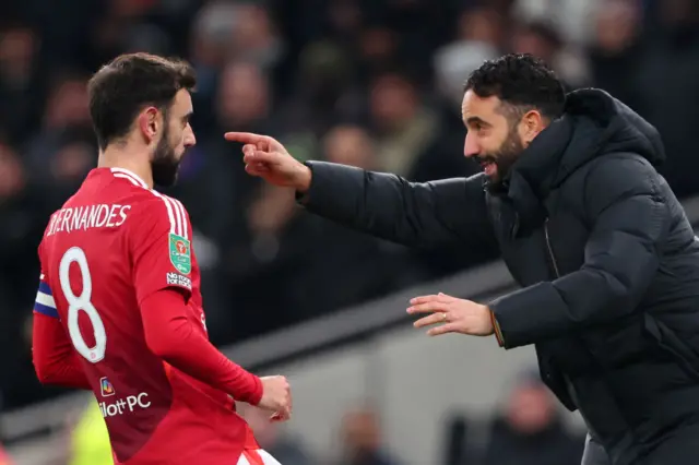 Manchester United manager Ruben Amorim with Bruno Fernandes during the Carabao Cup Quarter Final match between Tottenham Hotspur and Manchester United at Tottenham Hotspur Stadium on December 19, 2024 in London, England.