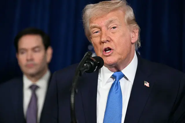Us President Donald Trump speaks during a press conference as Secretary of State Marco Rubio stands behind him to his right