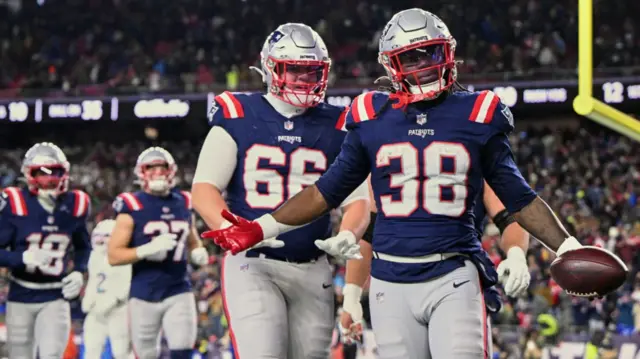 New England Patriots running back Rhamondre Stevenson celebrates after scoring a touchdown against the Miami Dolphins