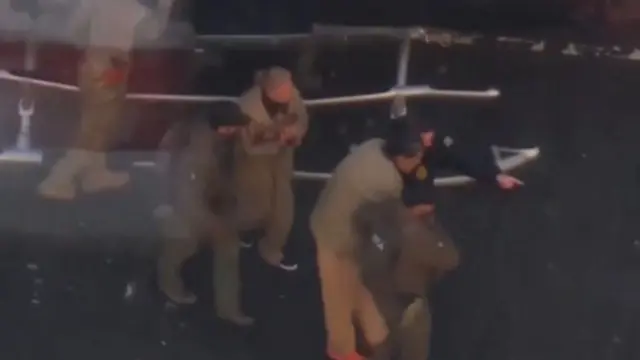 Maduro and wife escorted off helicopter