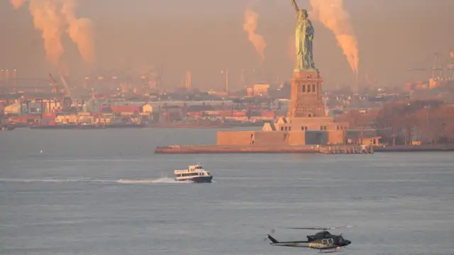 A helicopter carrying Maduro flies in front of the Statue of Liberty in New York City