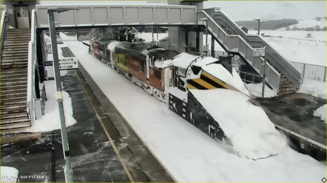 Snowplough pictured clearing snow from the rail path