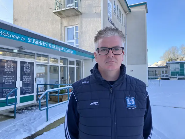 Philip McCullagh stands outside St Patrick and St Brigid's College