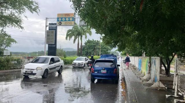 A landscape image of a road with cars travelling towards the camera