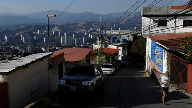 An unidentified man jogs through a Caracas street