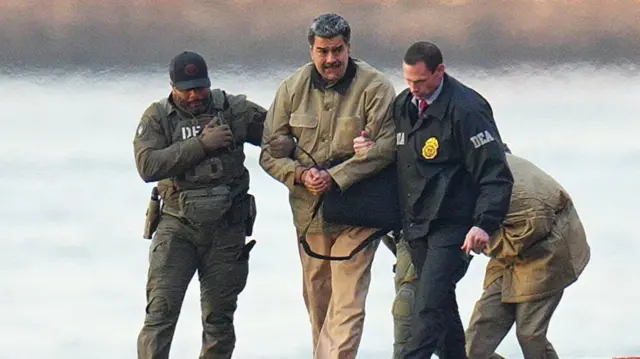 Nicolas Maduro is seen in handcuffs after landing at a Manhattan helipad, escorted by heavily armed federal agents as they make their way into an armoured car en route to a Federal courthouse in Manhattan