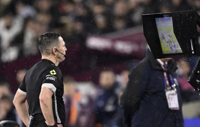 Referee Tony Harrington during a VAR review
