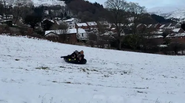 Children sledding in Denbigshire