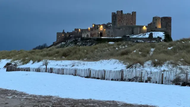 Castle on a hill with snow on the ground below