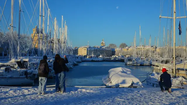 Snow-covered boats are moored at La Rochelle in Western France