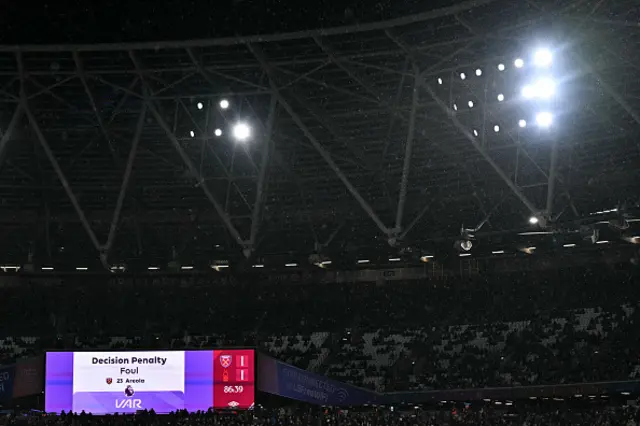 A giant screen displays the VAR decision for a penalty