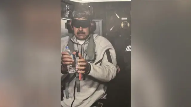 Maduro with ear defenders and a blindfold on