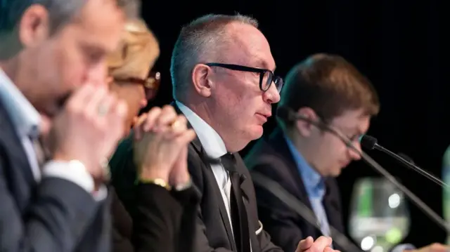 A side view of the mayor speaking at the news conference