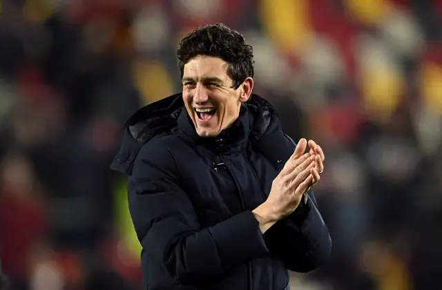 Keith Andrews, Manager of Brentford, acknowledges the fans
