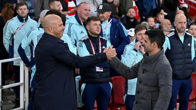 Arne Slot head coach of Liverpool embracing Mikel Arteta manager of Arsenal