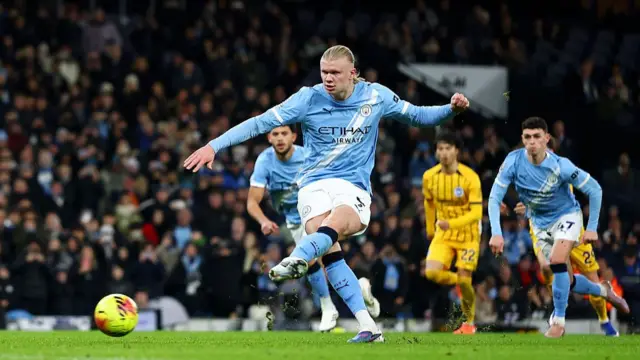 Erling Haaland of Manchester City scores from the penalty spot