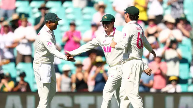 Usman Khawaja of Australia heads out