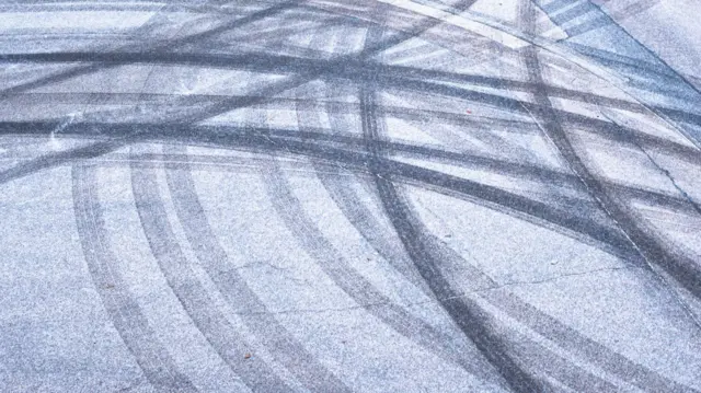 Skid marks on icy road