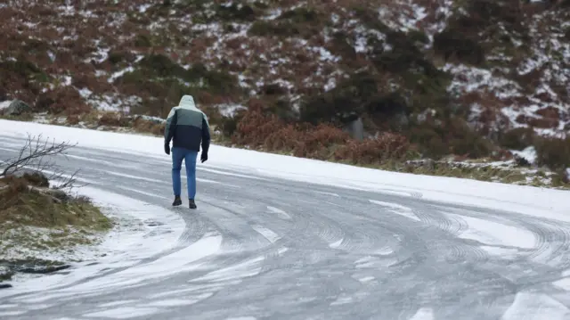 Man walking on icy road
