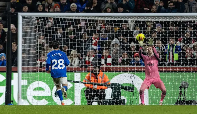 Brentford's goalkeeper Caoimhin Kelleher saves a penalty taken by Sunderland's Enzo Le Fee