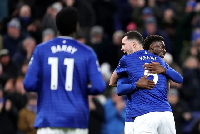 Everton's Michael Keane celebrates scoring with teammate Tim Iroegbunam. Barry looks on nearby