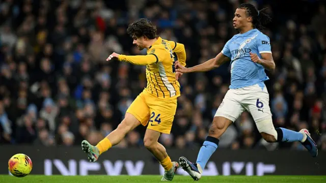 Ferdi Kadioglu of Brighton shoots while under pressure from Nathan Ake