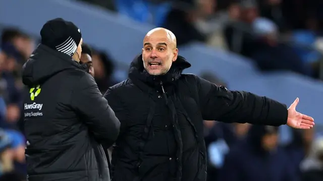 Pep Guardiola remonstrates with an official