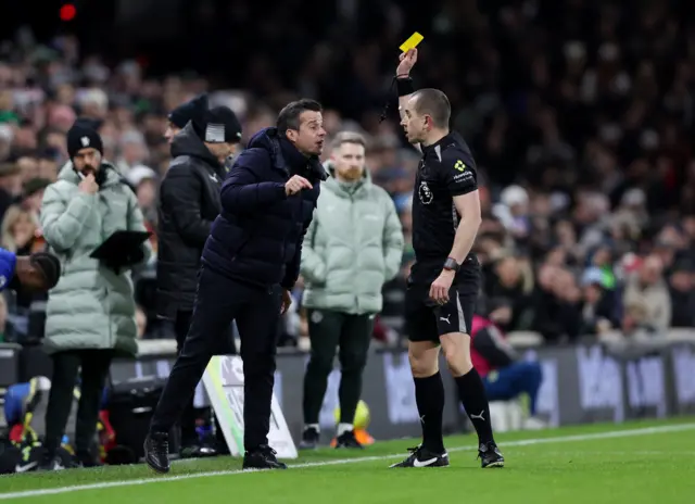 Fulham manager Marco Silva is shown a yellow card by referee Peter Bankes