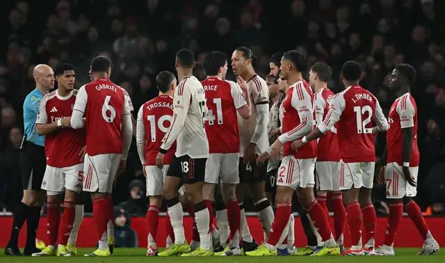 Virgil van Dijk of Liverpool remonstrates with Arsenal players